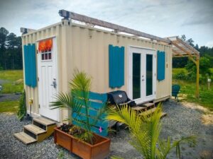 Colorful shipping container house with patio