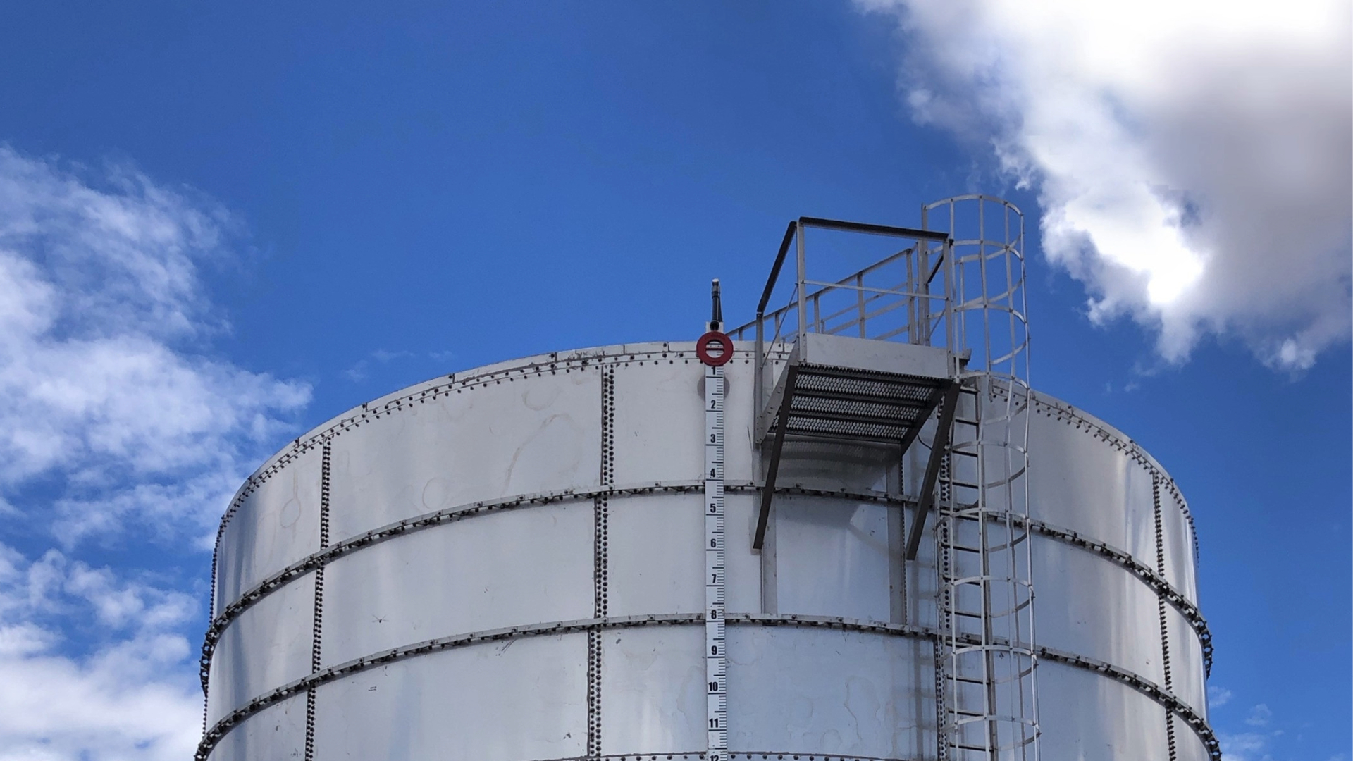 Industrial water storage tank against blue sky